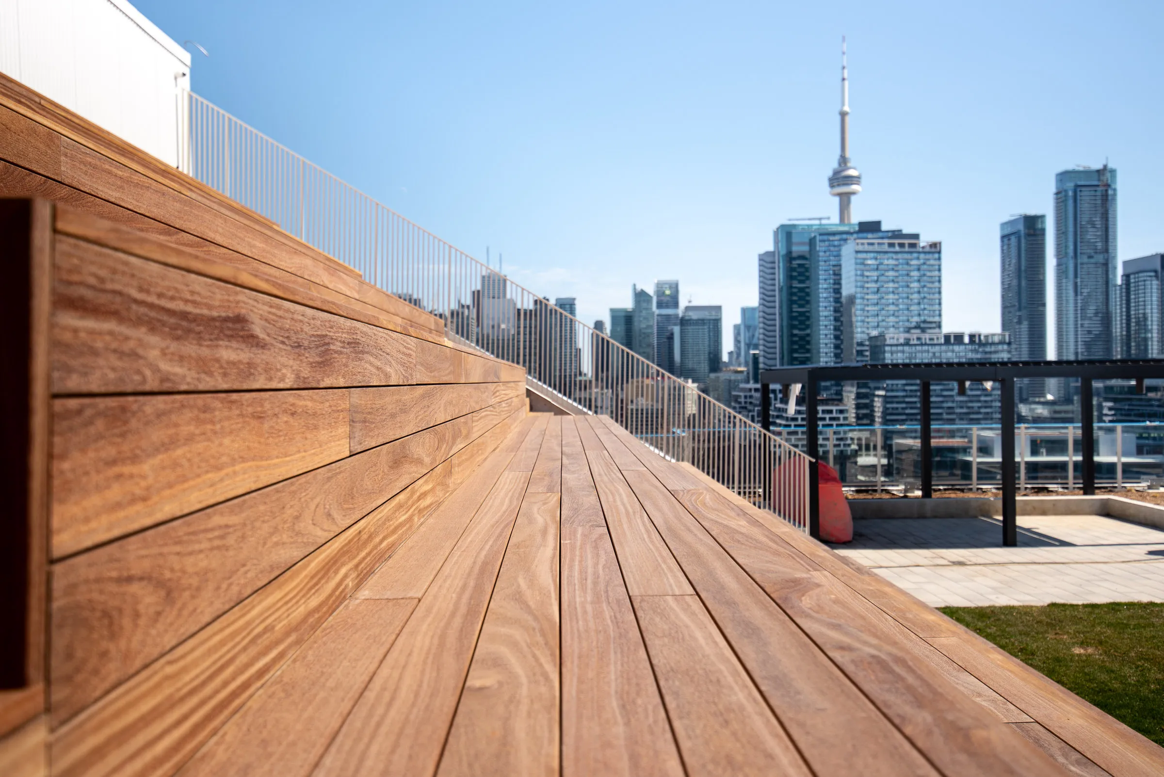 Cumaru decking and tiered wood seating overlooking Toronto’s CN Tower