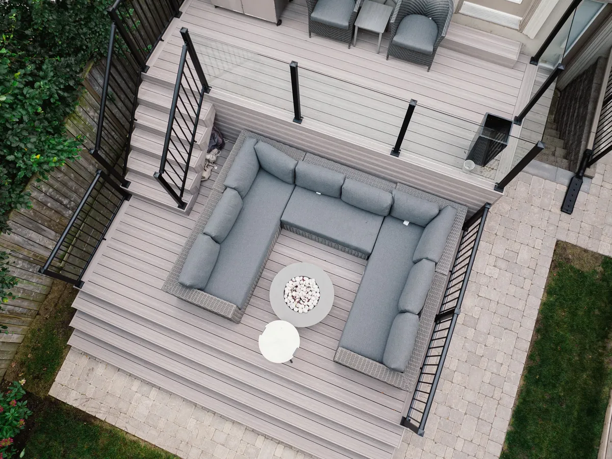 Two-level Fiberon composite deck with contrasting board edges, broad steps and glass and picket guards