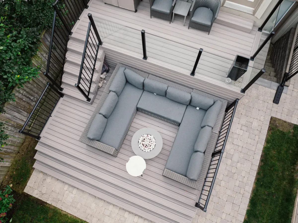 Two-level Toronto deck combining clear glass railing panels with black aluminum pickets