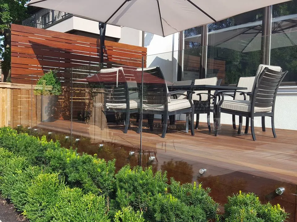 Completed Ipe deck with a frameless glass railing and privacy screen.