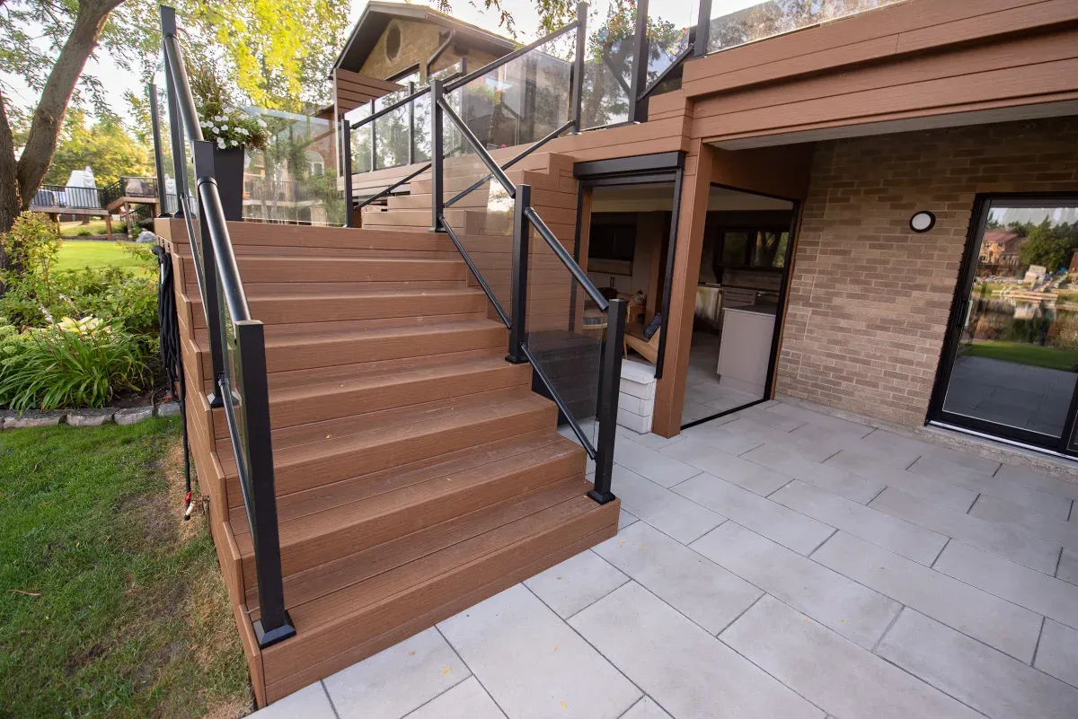 Composite deck stairs and glass railing — the parts that move a material estimate most.