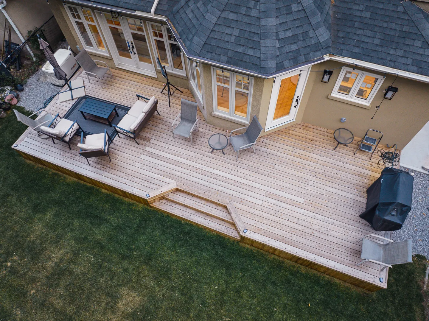 Lunawood deck with broad steps, an outdoor lounge and dining space beside a Toronto home