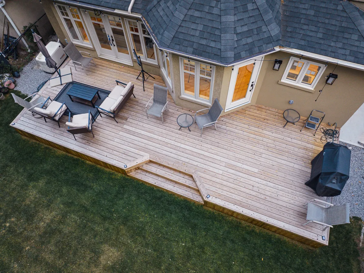 Lunawood deck with broad steps, an outdoor lounge and dining space beside a Toronto home