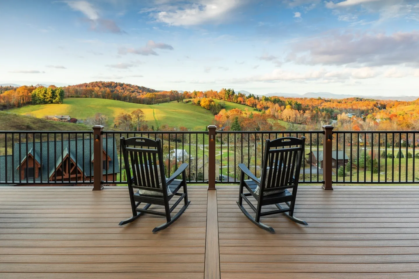 Black aluminum picket railing on a Trex composite deck in a warm board tone